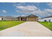 Charming single-story home with a long driveway and a well-maintained front yard, showing curb appeal at 212 Fig Ct, Poinciana, FL 34759