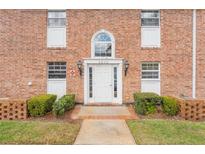 Charming brick building showcasing a front door with transom window and decorative black sconces at 4212 Lake Underhill Rd # 5, Orlando, FL 32803