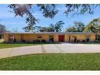 Charming single-story home features well-manicured lawn, long drive, and a stylish front entrance at 926 Ensenada Dr, Orlando, FL 32825