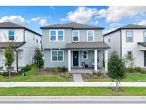 Charming two-story home with welcoming front porch, landscaped yard and covered entry at 17019 Seville Orange Rd, Winter Garden, FL 34787