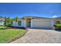 Charming single-story home featuring a well-manicured lawn and a brick driveway at 1010 High Vista Dr, Davenport, FL 33837