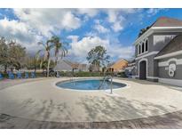 Well-maintained community pool with a clubhouse and lounge chairs for residents' enjoyment at 13046 Island Breeze Ct, Orlando, FL 32824