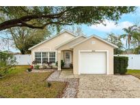 Charming single-story home with a well-manicured lawn, attached garage, and inviting entrance at 15848 Autumn Glen Ave, Clermont, FL 34714