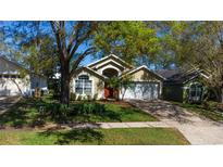 Charming single Gathering home featuring a well-manicured lawn and mature trees for ample shade at 17343 Summer Oak Ln, Clermont, FL 34711