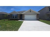 Charming single-story home featuring a two-car garage and well-manicured lawn at 1861 Walnut Creek Dr, Kissimmee, FL 34744