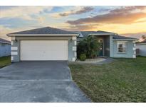 Charming single-story home with a two-car garage and a well-manicured lawn at 1879 Grey Fox Dr, Lakeland, FL 33810