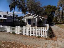 Charming cottage with a white picket fence and front yard at 204 S Center St, Eustis, FL 32726