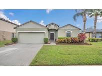 Charming single-story home with a well-maintained lawn and attached two-car garage at 2233 Tulip Valley Pt, Sanford, FL 32771