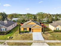 Charming single-Gathering home with a two-car garage and well-maintained landscaping at 281 Edisto Pl, Apopka, FL 32712