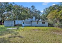 Charming single-story home with a quaint front yard and mature trees providing ample shade at 3508 Rouse Rd, Orlando, FL 32817