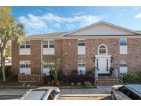 Charming brick condo building with a well-maintained entrance and landscaped garden at 4214 Lake Underhill Rd # A, Orlando, FL 32803