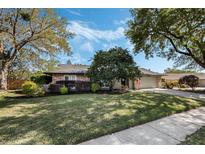 Charming stone-accented home with lush landscaping and mature trees at 460 Forestwood Ln, Maitland, FL 32751