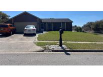 Charming single Gathering home with a well-maintained lawn and a private driveway for multiple vehicles at 6360 Powerpointe, Orlando, FL 32818