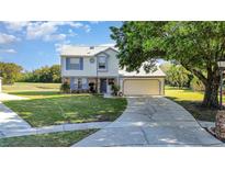 Charming two-story home featuring a well-manicured lawn and an attached two-car garage at 8155 Brocatel Ct, Orlando, FL 32822