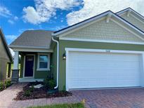 Charming home with a two-car garage, well-maintained landscaping, and inviting curb appeal at 2668 Spider Lily Ct, Clermont, FL 34711