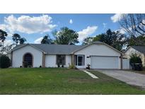 Charming single Gathering home featuring a well-maintained lawn and attached two-car garage at 272 Loma Bonita Dr, Davenport, FL 33837