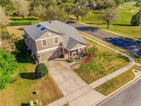 Attractive two-story home with a two-car garage, well-kept lawn, and neatly landscaped front entry at 34000 Fortunado St, Sorrento, FL 32776