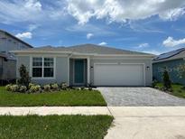 Charming single-story home featuring a manicured lawn, neutral palette, and a spacious two-car garage at 6920 Dappled Oak Way, Orlando, FL 32829