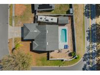 Aerial view of a home with a private pool, patio, RV parking, and white fenced yard at 100 Diamond Ridge Blvd, Auburndale, FL 33823