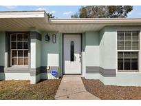 Close-up of the front door with decorative details and a keypad lock system at 12419 Eryn Ct, Clermont, FL 34711