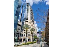 Modern high rise building with ground level landscaping on sunny day at 155 S Court Ave # 2106, Orlando, FL 32801