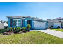 Charming single-Gathering home featuring a well-manicured lawn and a two-car garage at 1671 Spray Ter, St Cloud, FL 34771