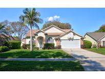 Charming single-story home featuring a lush green lawn and a well-maintained front yard with mature landscaping at 304 Silver Pine Dr, Lake Mary, FL 32746