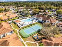 Resort-style living with a pool, spa, and tennis court surrounded by well-maintained landscaping and lush trees at 3208 Sabal Palms Ct # A, Kissimmee, FL 34747