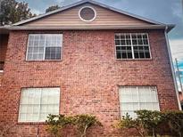 Charming brick exterior with well-maintained landscaping at 4275 Perkinshire Ln # 204, Orlando, FL 32822