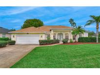 Inviting single-story home with a well-manicured lawn and lush landscaping at 460 Quail Hill Dr, Debary, FL 32713