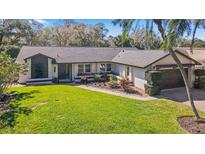 Charming single Gathering home with a well-manicured lawn and beautiful landscaping at 5140 Honeynut Ln, Windermere, FL 34786