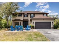 Stately two-story home featuring a charming front yard and a spacious two-car garage at 6346 Dallas Blvd, Orlando, FL 32833