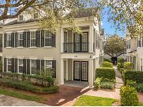 Beautiful townhome with a brick walkway, lush landscaping, and a covered front porch and balcony at 1531 Lake Baldwin Ln, Orlando, FL 32814