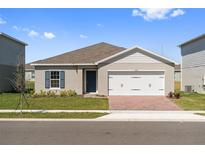 Charming single-Gathering home featuring a two-car garage and well-maintained lawn at 1630 Laia Rd, Haines City, FL 33844