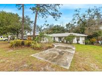 Charming single-story home with mature trees, a driveway, and a well-maintained front yard at 257 Sheppard St, Altamonte Springs, FL 32701