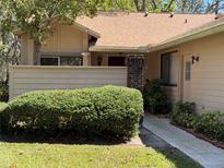 Charming single-story home featuring a brick pillar, manicured lawn, and mature landscaping at 417 Evesham Pl, Longwood, FL 32779