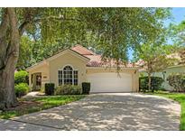 Charming single-story home with a well-manicured lawn, mature trees, and a two-car garage at 763 Via Milano, Apopka, FL 32712