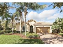 Charming single-story home with a tile roof, mature landscaping, and a brick driveway at 11866 Barletta Dr, Orlando, FL 32827