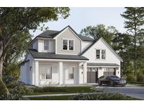 Elegant exterior showcases a modern two-story home with a two car garage and manicured lawn at 1702 Arbor Park Dr, Winter Park, FL 32789