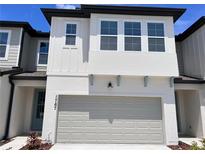 Charming two-story home featuring a spacious garage and a well-maintained front yard at 1767 Sanibel Dr, Davenport, FL 33896