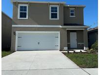 Inviting two-story home with a two car garage and manicured lawn at 3170 Partington Blvd, Davenport, FL 33837