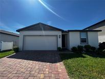 Charming one-story home with a brick driveway and well-maintained landscaping at 464 Patricia Alford Dr, Haines City, FL 33844