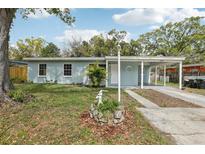 Charming one-story home with well-maintained front yard and covered carport at 5215 Ashwood Pl, Orlando, FL 32808