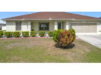 Charming single-story home with a well-maintained lawn and a two-car garage at 5361 Se 92Nd St, Ocala, FL 34480
