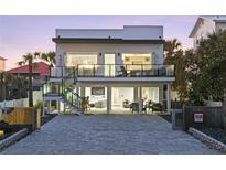 Modern two-story home featuring a beautiful patio and balcony, perfect for outdoor living at 6480 S Atlantic Ave, New Smyrna Beach, FL 32169