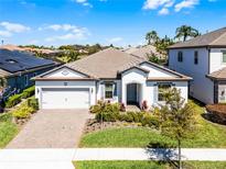 Charming single-story home featuring a well-manicured lawn and a two car garage in a sunny neighborhood at 7916 Wandering Way, Orlando, FL 32836