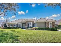 Beautiful single-story home with a well-manicured lawn and lush landscaping at 12848 Jacob Grace Ct, Windermere, FL 34786