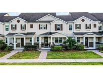 Charming two-story townhome featuring a well-manicured lawn and inviting front porch at 13727 Bressler Aly, Windermere, FL 34786