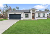 Charming single-story home featuring a well-manicured lawn and a two-car garage, perfect for suburban living at 16659 Sw 21St Avenue Rd, Ocala, FL 34473