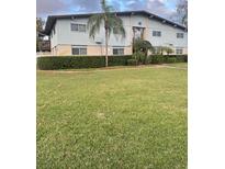 Charming two-story condo building with well-manicured lawn and privacy hedges at 1695 Lee Rd # C202, Winter Park, FL 32789